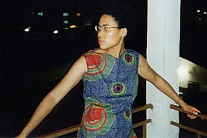 Erika stands on their balcony at H&ocirc;tel Babo.