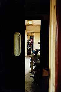 The second-class compartment is beyond the door.