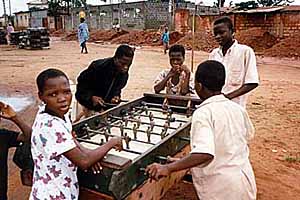 Kids play fusball in front of the museum.